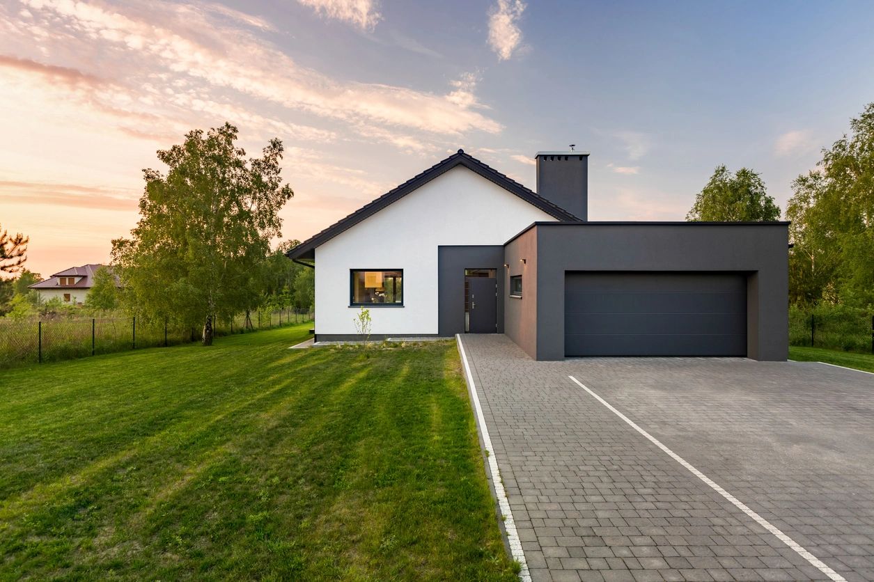 front yard and garage of a gray and white house